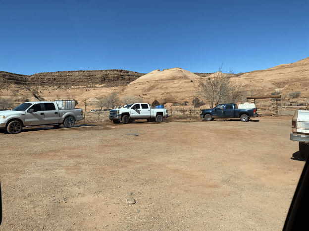 Trucks line up to fill water from local source in Monument Valley