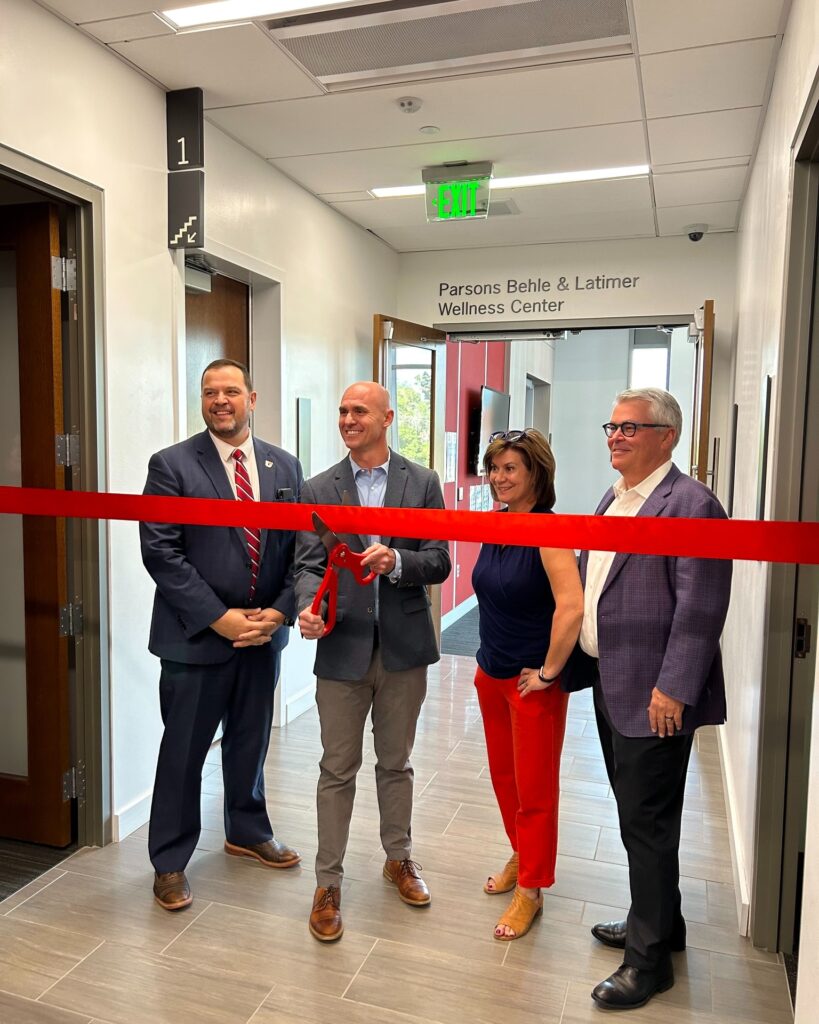 Leaders from law firm Parsons, Behle and Latimer cut a red ribbon to rename the wellness center
